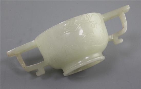 A Chinese pale celadon jade two handled cup, 17th / 18th century, 10.3cm